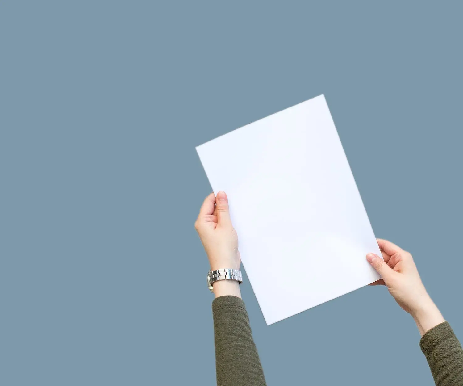 Hands holding blank white paper