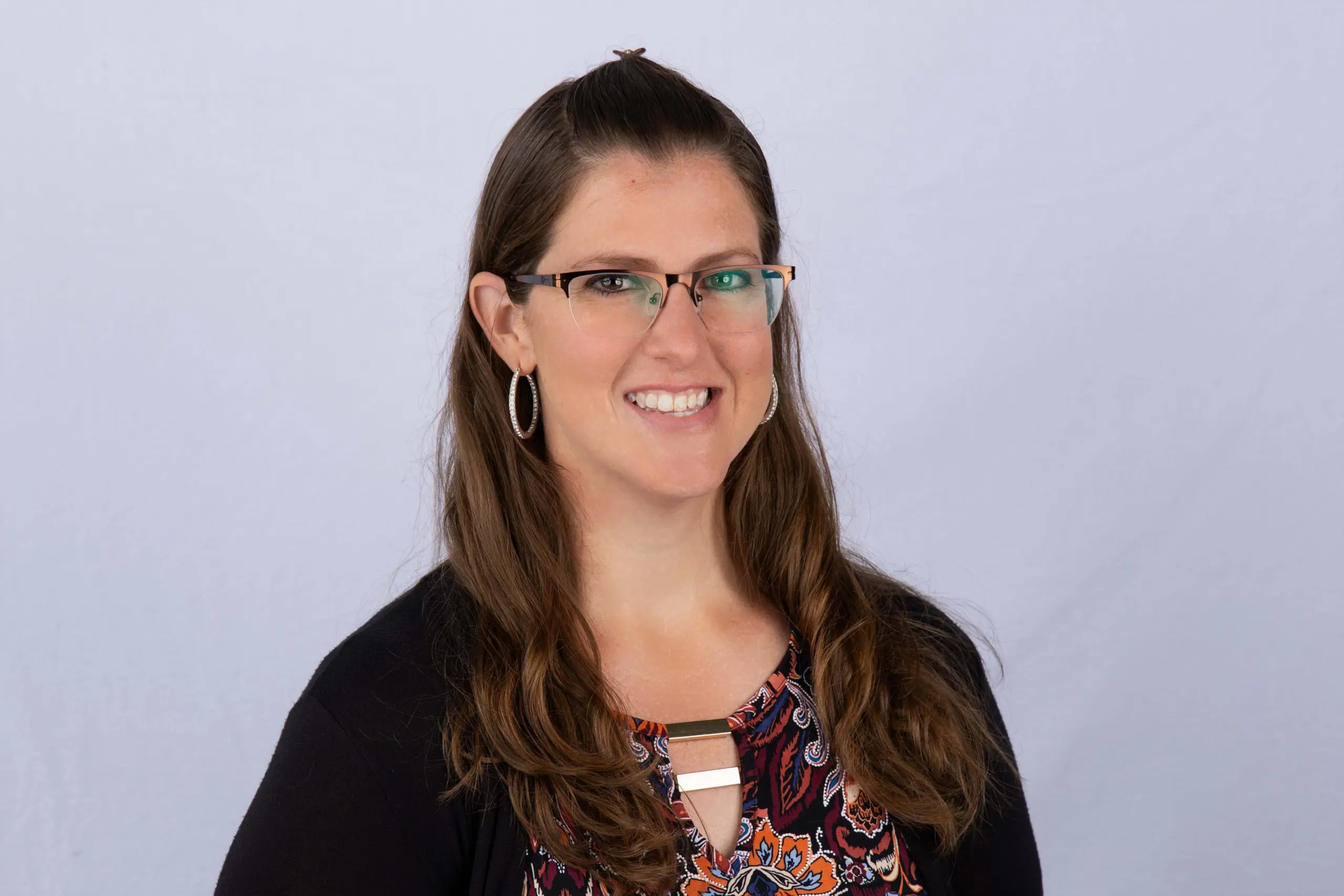 Photo of Kaitlin Garrett wearing glasses and a black sweater.