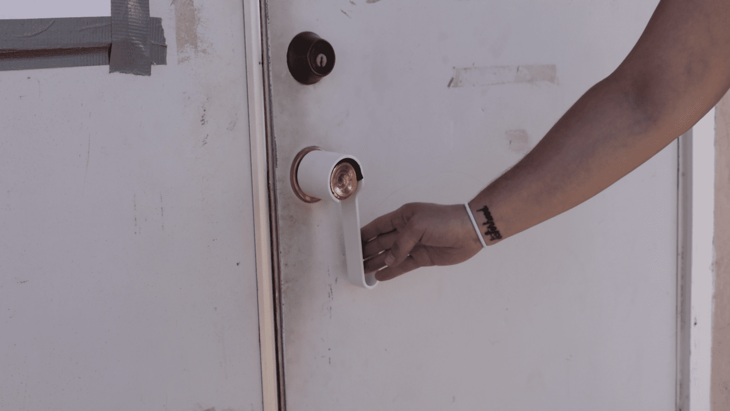 Round doorknob is outfitted with a retrofitted lever knob.
