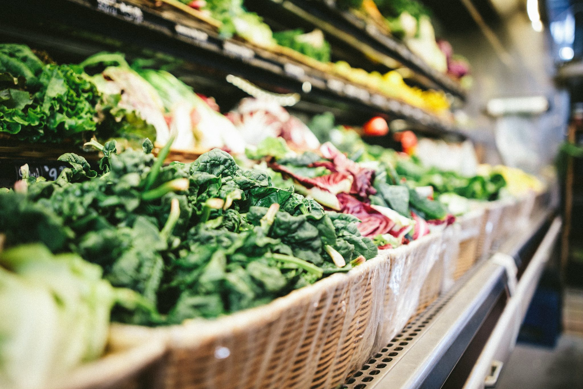 Row of fresh vegetables in a grocery store