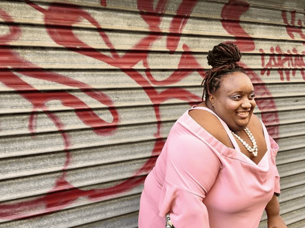 Portrait of Imani wearing a pink shirt and smiling