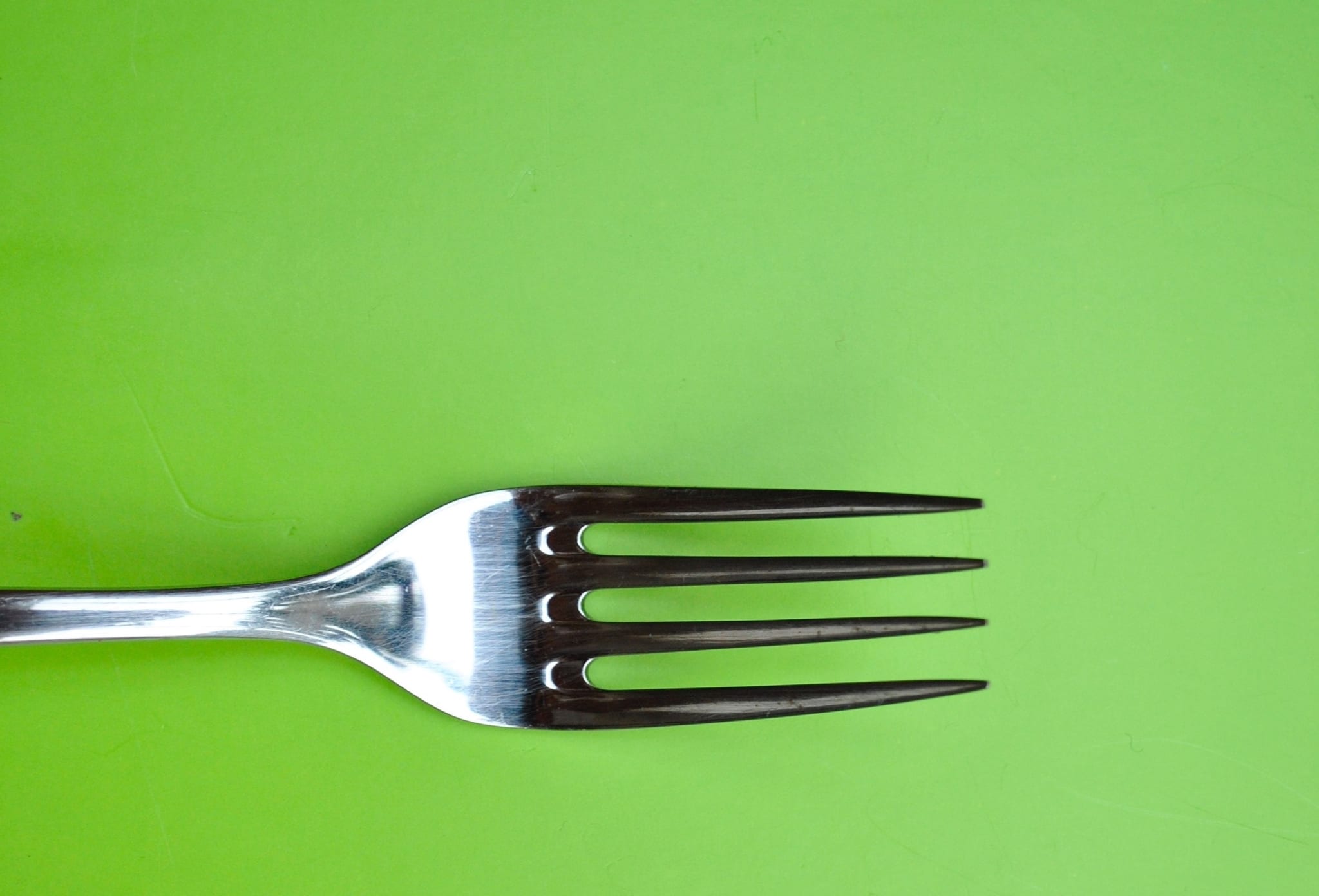 Fork on green background