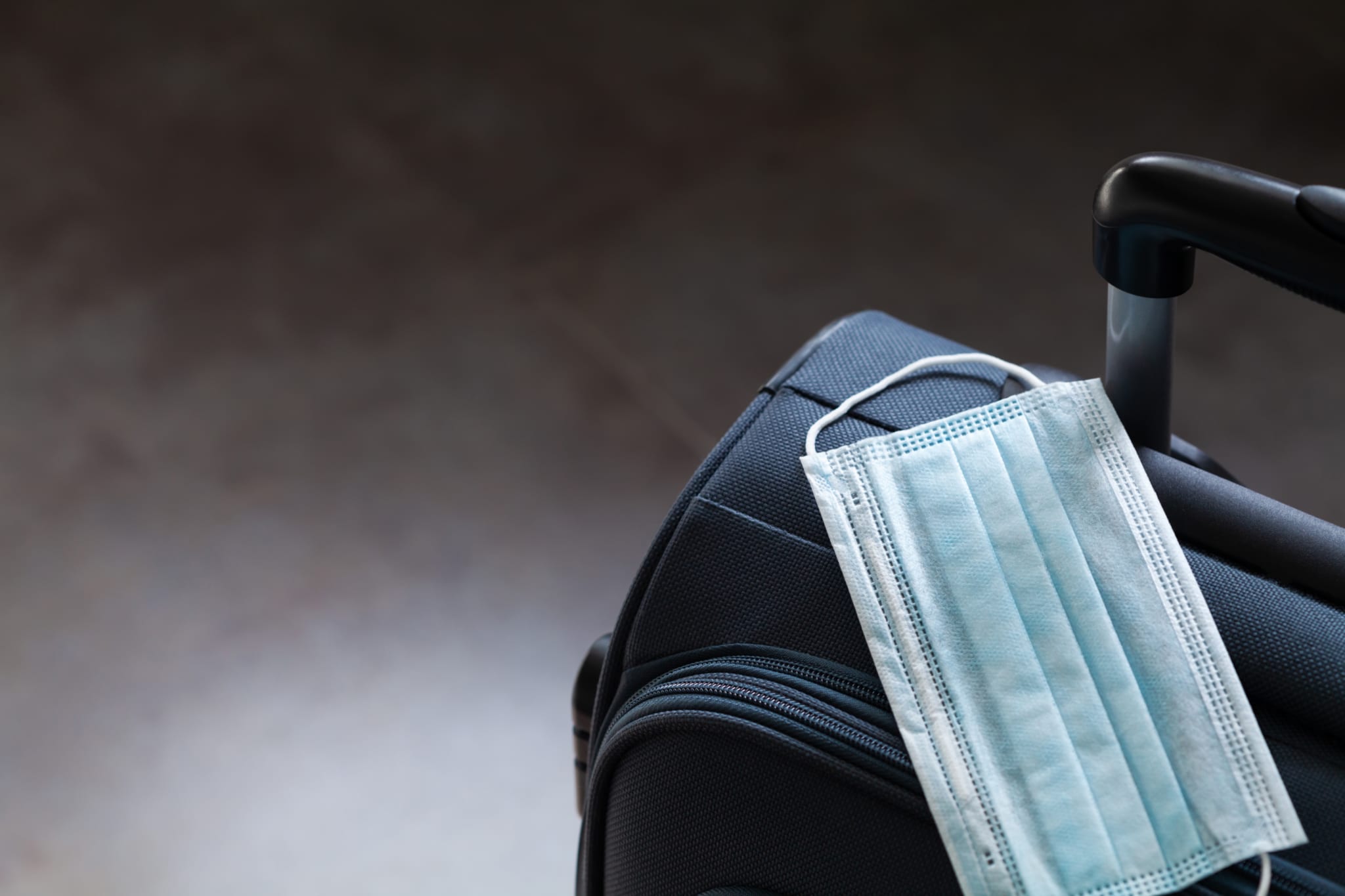 Disposable mask on a suitcase