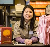 A grocery worker smiling at the camera