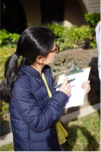 Person taking note on a clipboard