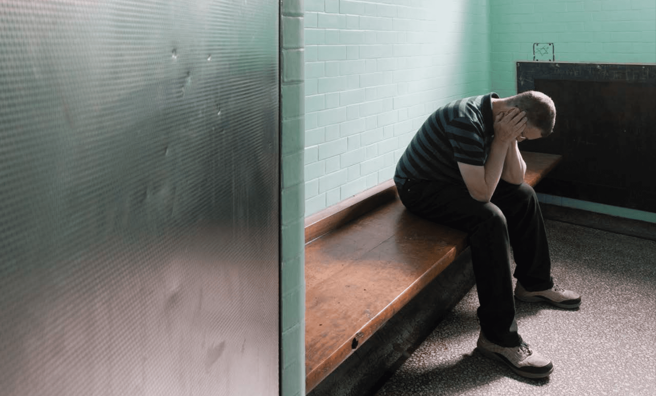 A young white male in a prison cell.