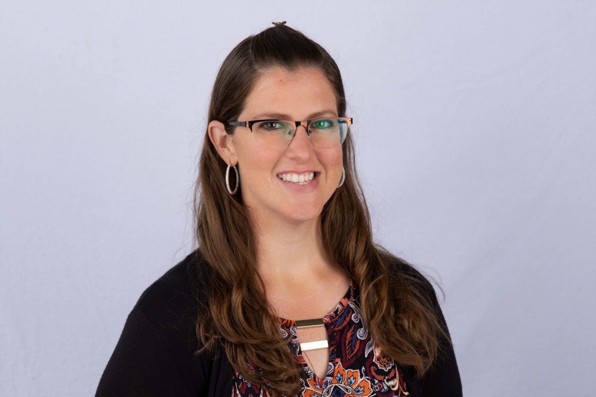 Photo of Kaitlin Garrett wearing glasses and a black sweater.