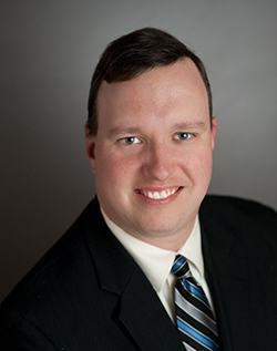 Image of Karl Cooper. He is wearing a suit and tie.